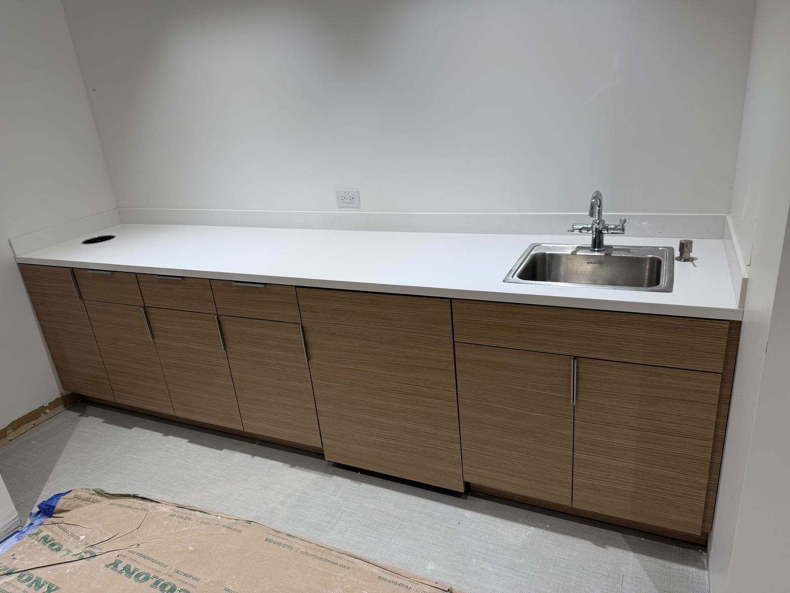 Finished cabinetry with countertop and sink installation