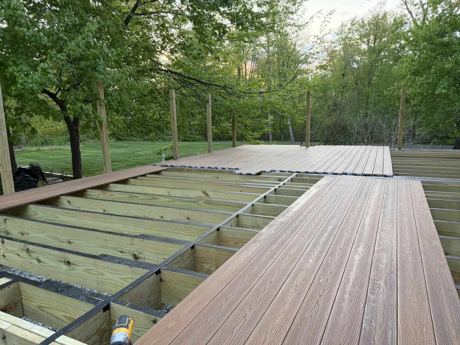 Installing composite decking boards over the deck frame